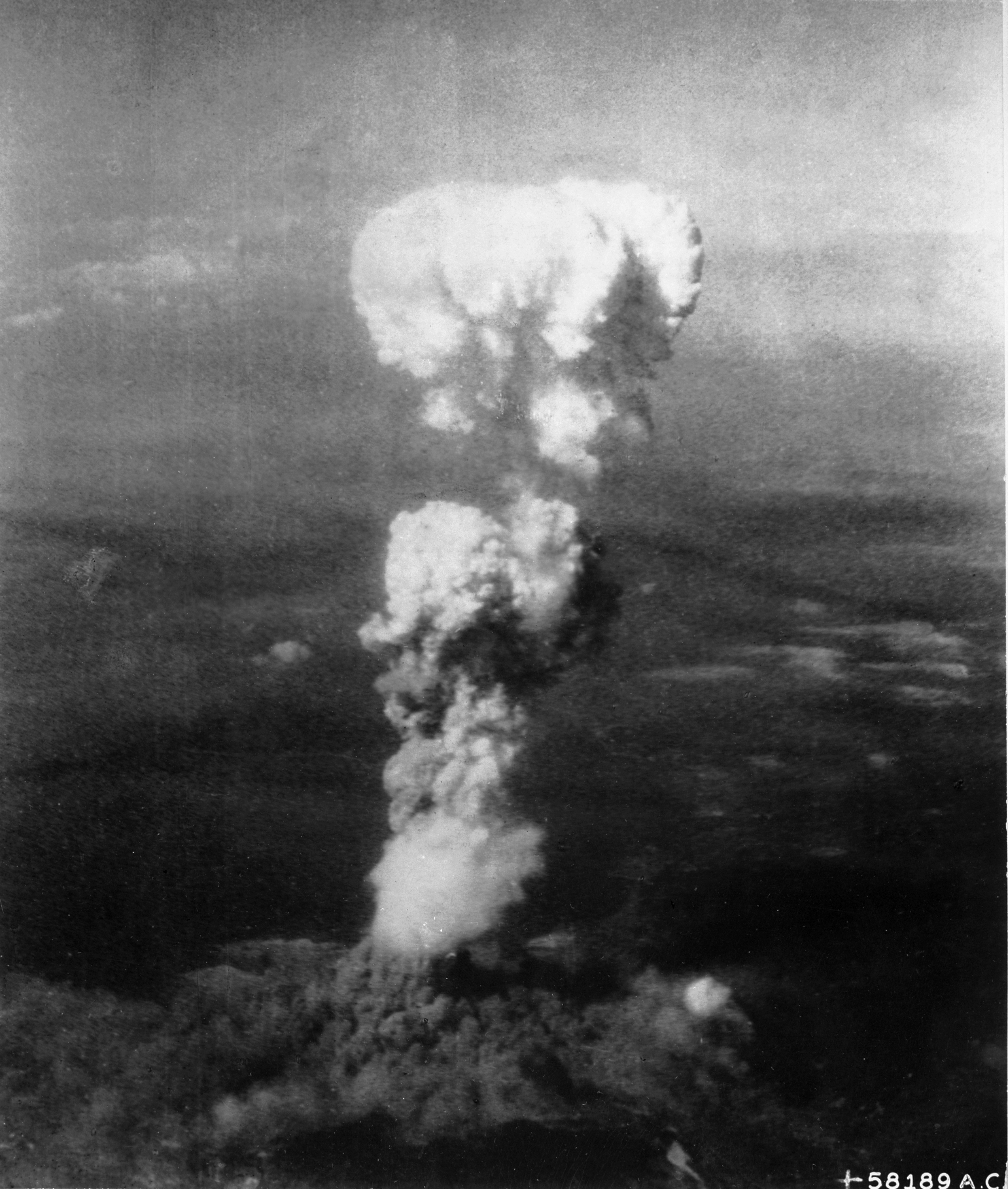 Black-and-white reconnaissance photograph of the mushroom cloud rising over Hiroshima on 6 August 1945.